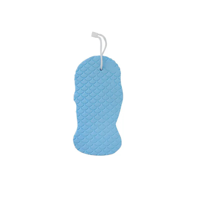 White 3D fish scale pattern bath sponge ball on a bathroom surface.