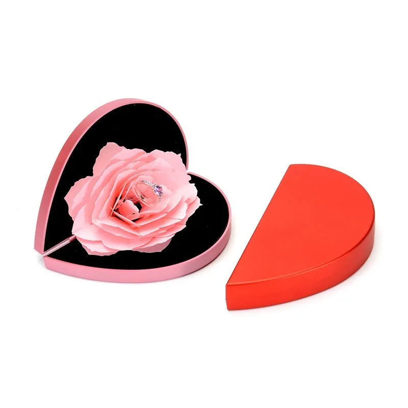 Red 3D heart-shaped rotating ring box with a rose flower decoration, open to show ring placement.