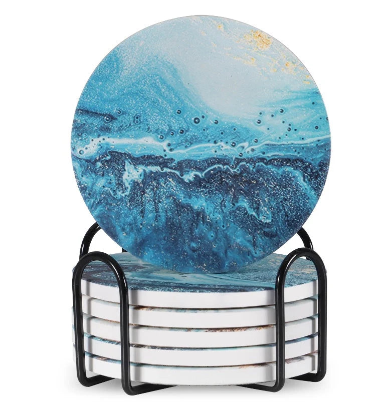 Set of 6 round ceramic coasters with metal stands and cork bases on a wooden table