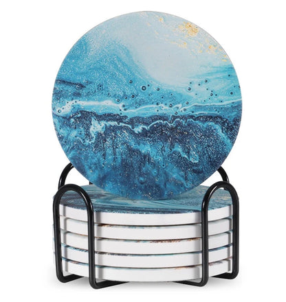 Set of 6 round ceramic coasters with metal stands and cork bases on a wooden table