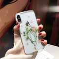 Handmade clear epoxy flower iPhone case with real dried flowers on soft TPU back cover.