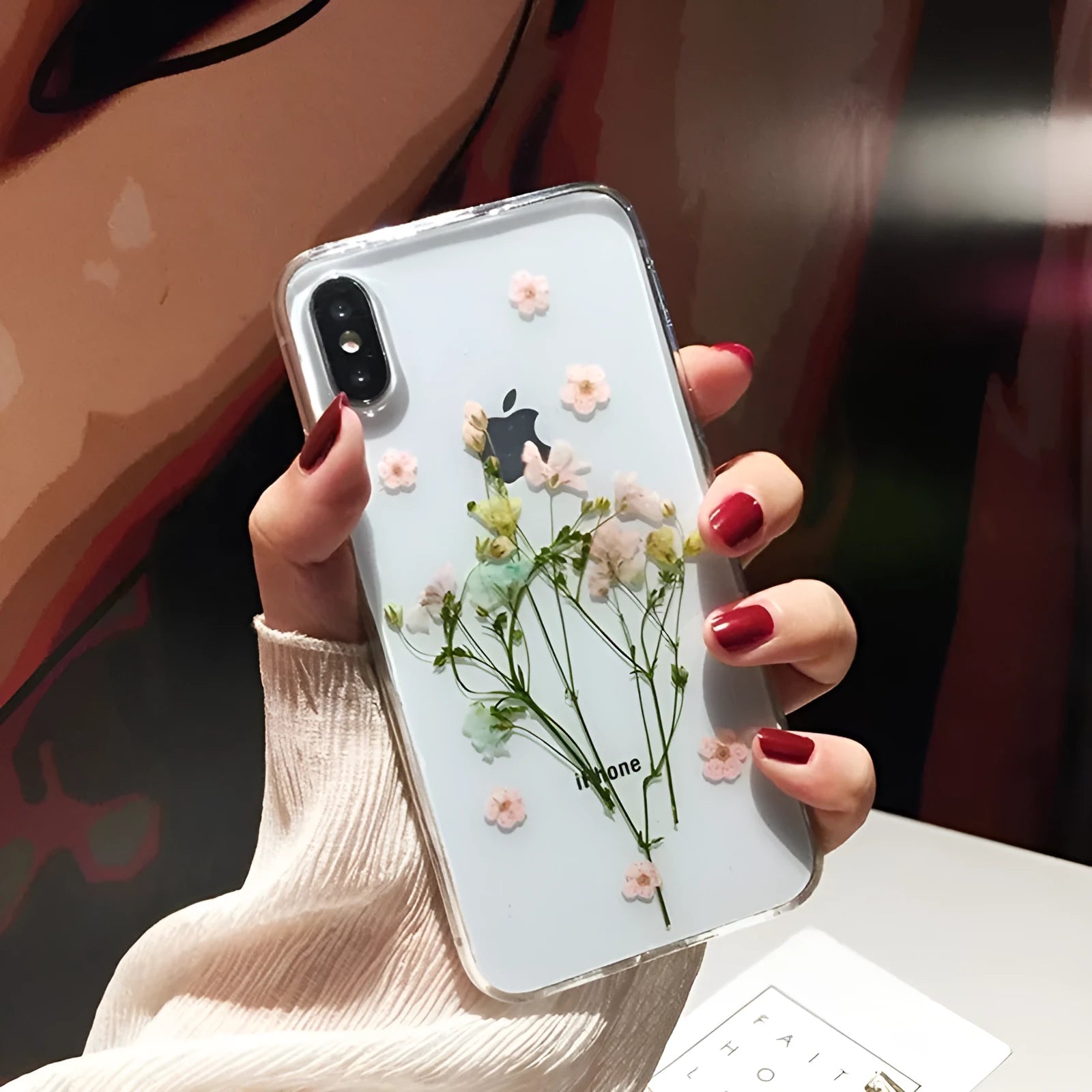 Handmade clear epoxy flower iPhone case with real dried flowers on soft TPU back cover.