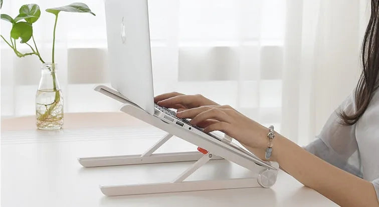 White portable laptop cooling stand with adjustable height and folding mechanism
