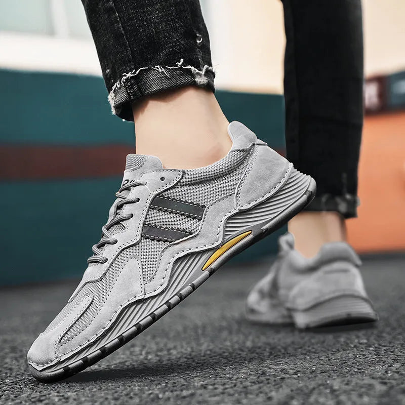 Men's low-top lace-up hiking boots in grey with pigskin upper and platform rubber sole.