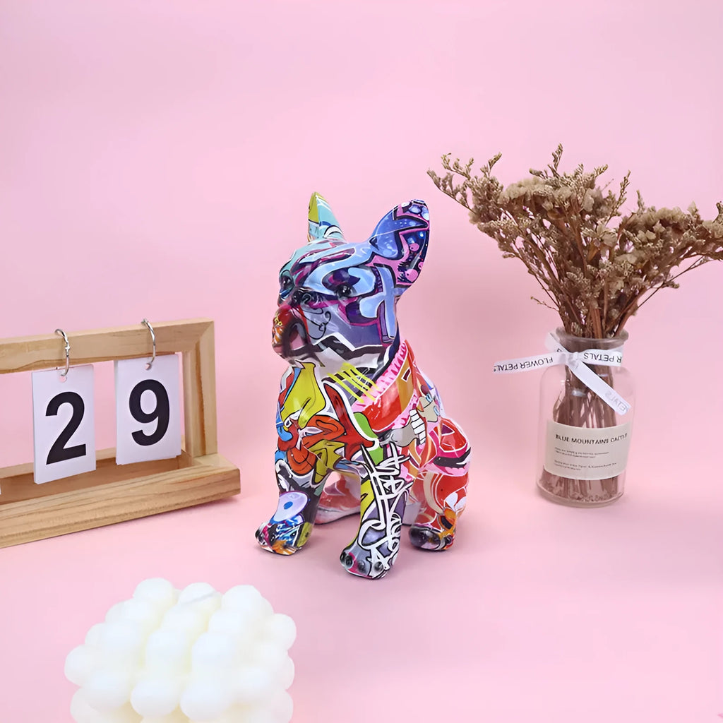 Modern simple French bulldog resin statue in graffiti colour finish on a plain background.