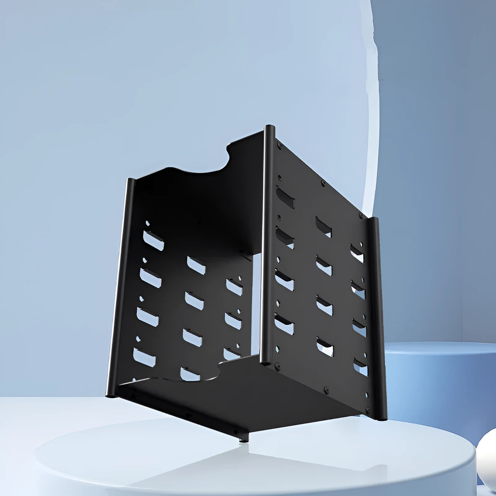 Black metal 5-layer 3.5-inch hard drive storage bracket with screwdriver and screw pack on a desk