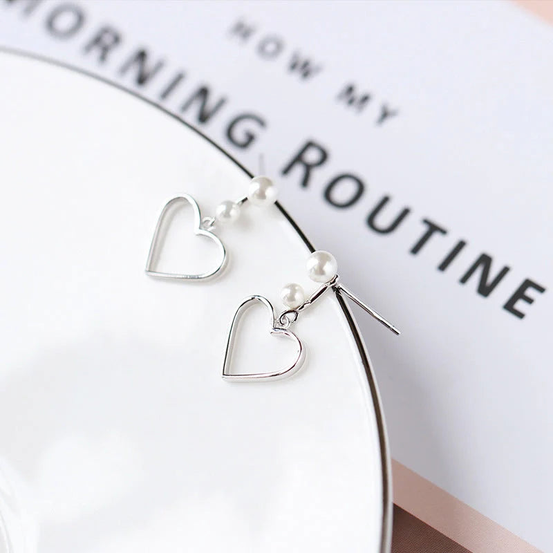 Hollow love earrings in S925 silver with heart shape design, lightweight and handcrafted
