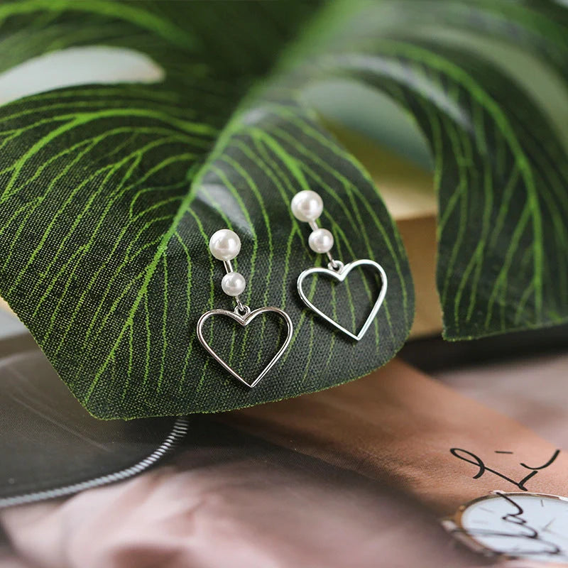 Hollow love earrings in S925 silver with heart shape design, lightweight and handcrafted