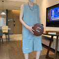 Men's white sleeveless basketball vest and matching shorts sportswear set laid flat.