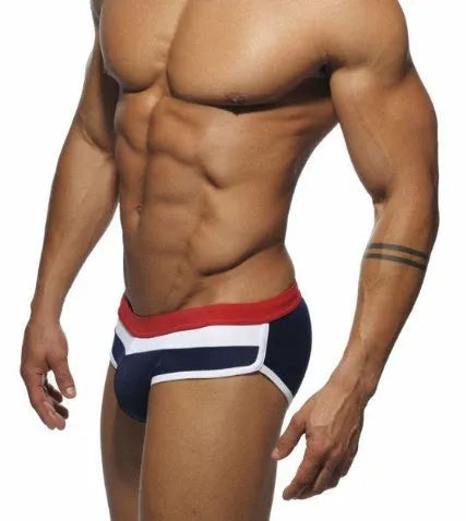 Men's nylon patchwork swim trunks in black with brief cut for swimming