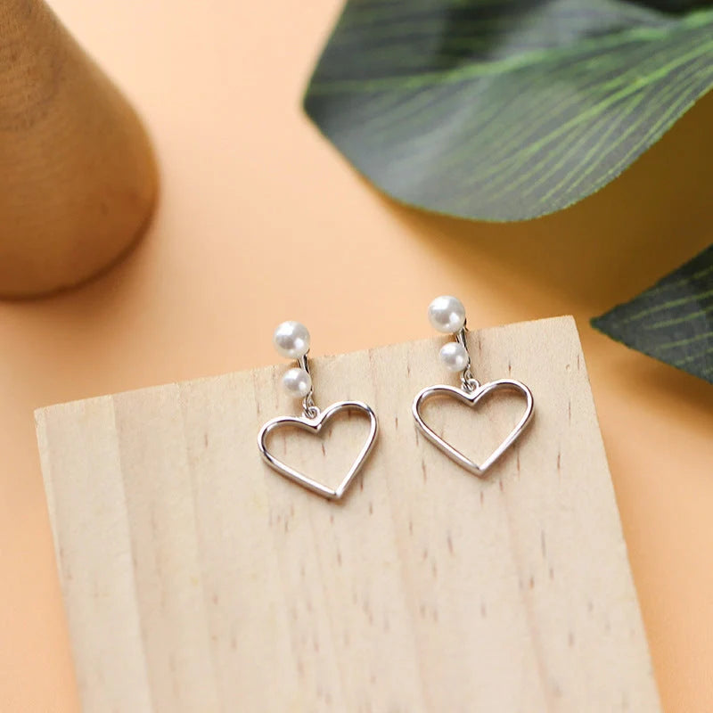 Hollow love earrings in S925 silver with heart shape design, lightweight and handcrafted