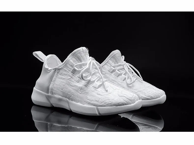 Casual loafers for men and women with fly woven upper, flat heel, and luminous accents in white colour option