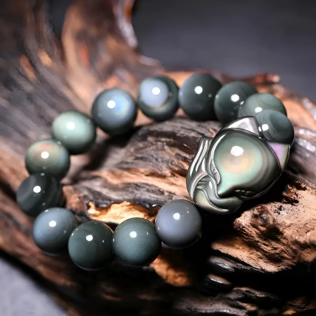 Black obsidian stone bracelet with carved fox design in cartoon style, showing texture and adjustable sizing