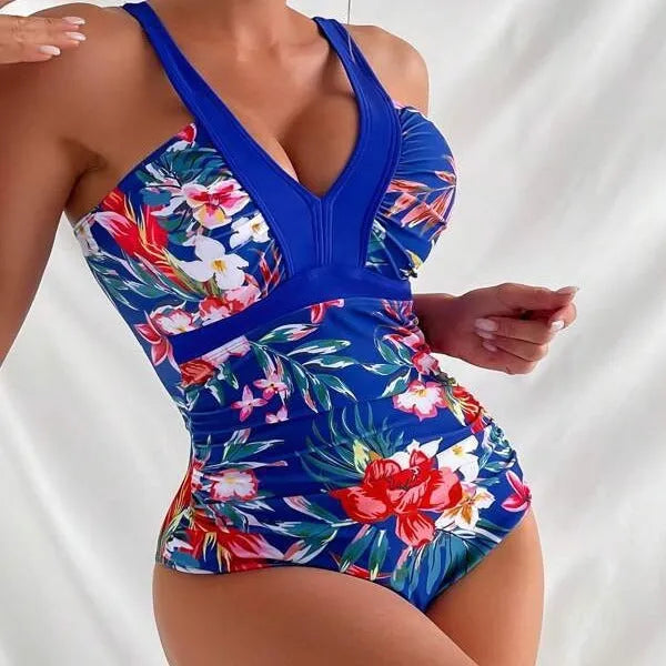 Women's black floral print one-piece swimsuit with a backless design.