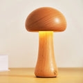 Solid beech wood mushroom shaped LED bedside lamp with warm light on a wooden nightstand