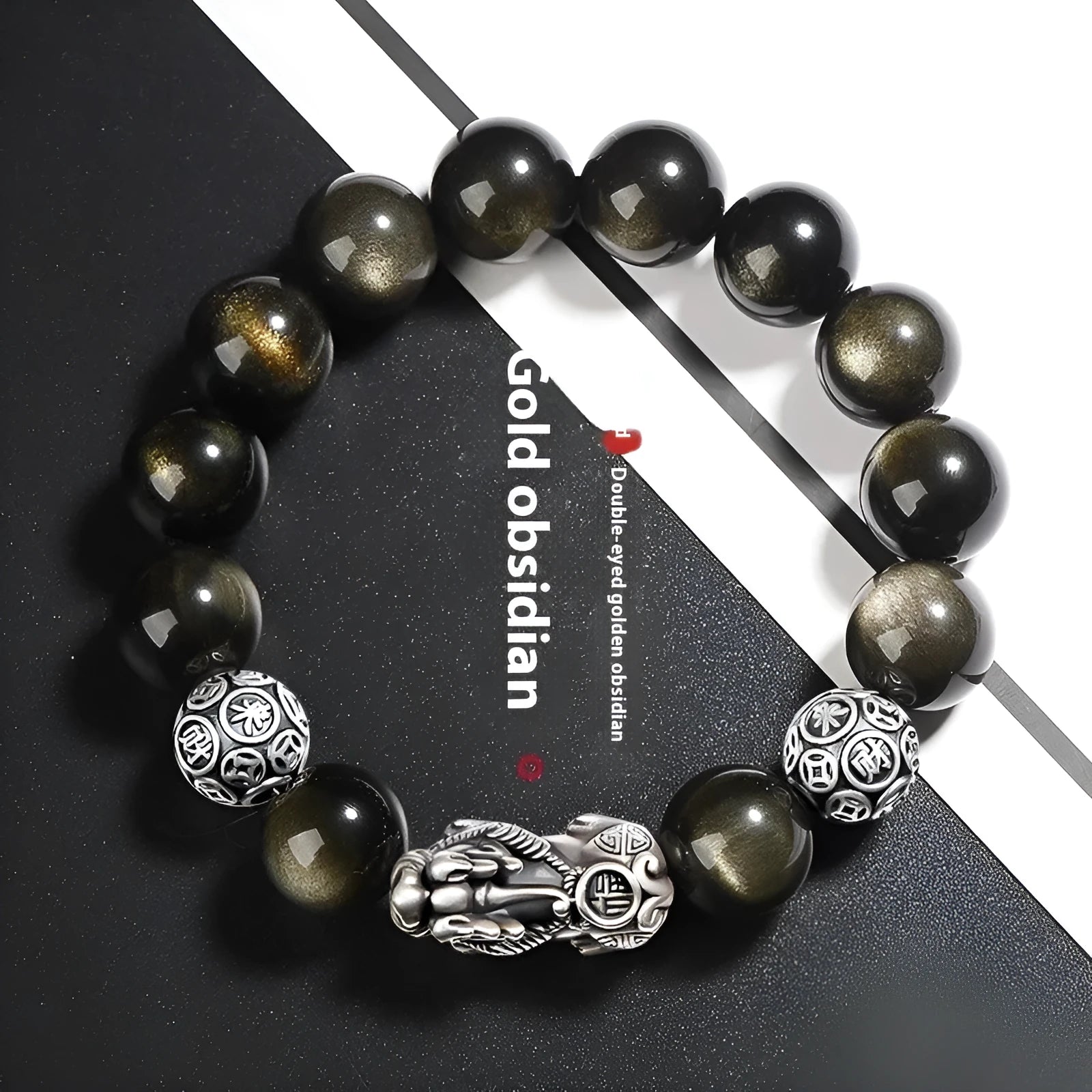 Men's geometric bracelet made of black obsidian and polished 999 sterling silver, showing its width and structured design.