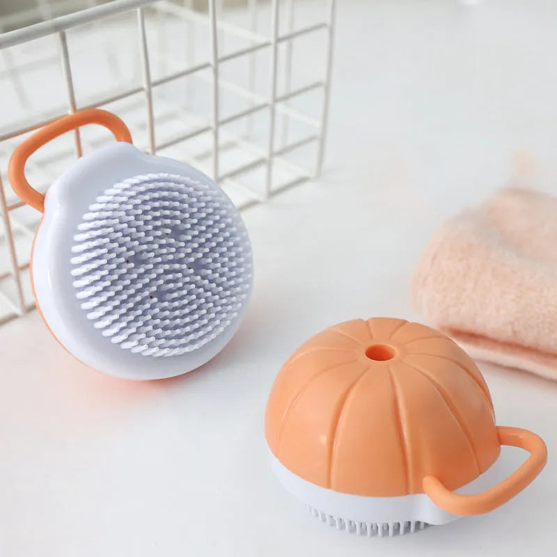 Orange dog bath brush with shampoo dispenser and soft TPR bristles for pet grooming