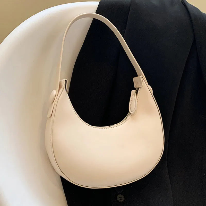 Retro dumpling-shaped women's shoulder bag in PU leather, shown in a choice of four colours.