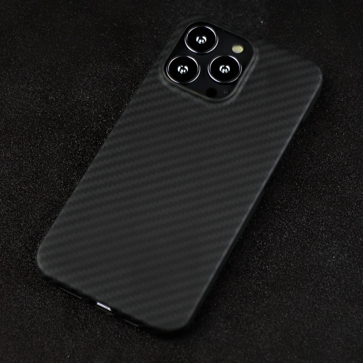 Matte black Kevlar fibre iPhone 12 case with crater texture and exposed buttons for drop protection