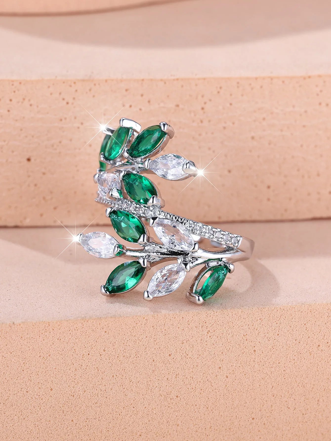 Adjustable copper leaf ring with a zircon stone in a choice of rose gold or platinum finishes.