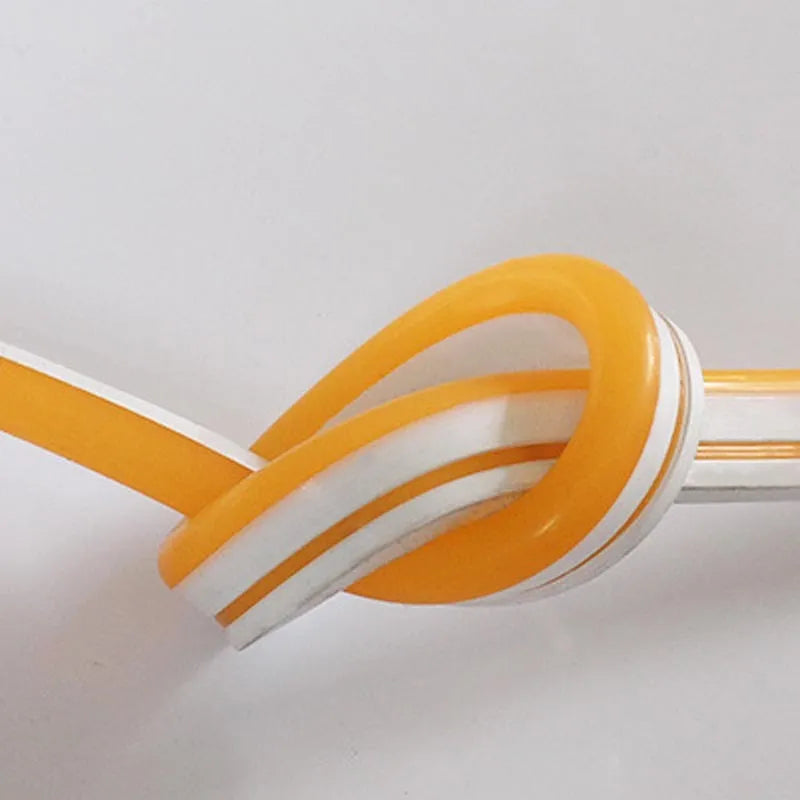 A 100-metre reel of flexible blue LED neon strip light showing its bendable silicone construction and bright illumination.