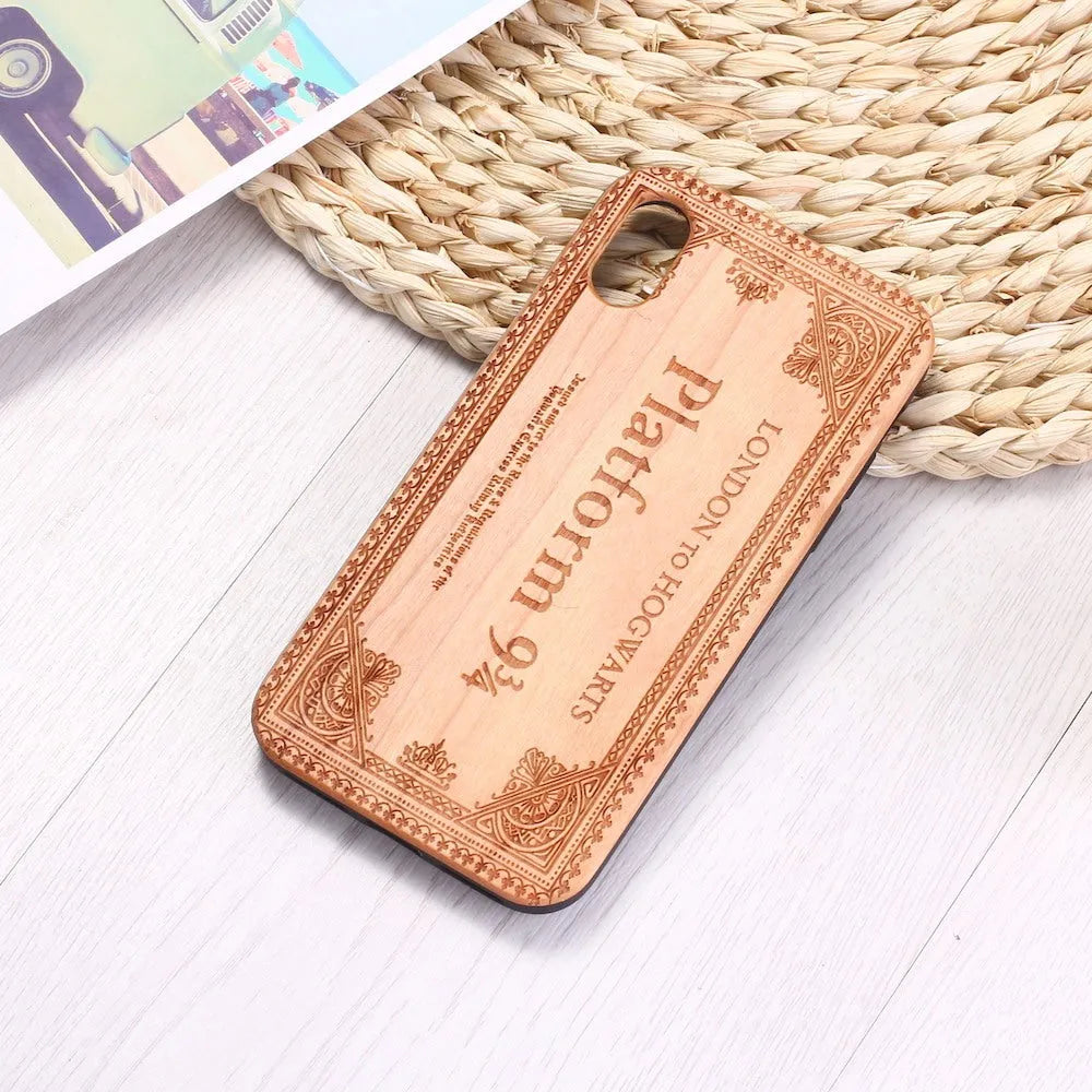 Wooden iPhone case with laser-carved floral design and black TPU bumper on a rosewood back.