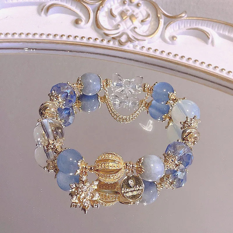 Women's galaxy colour bracelet with snowflake pendant and bow design elements