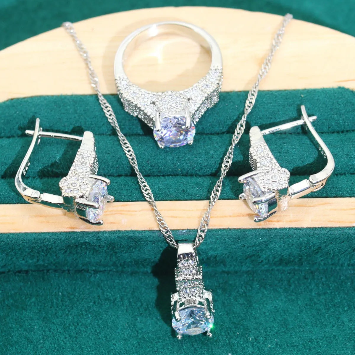 Bridal zircon four-piece jewellery set showing necklace, bracelet, earrings and ring with water wave chain design