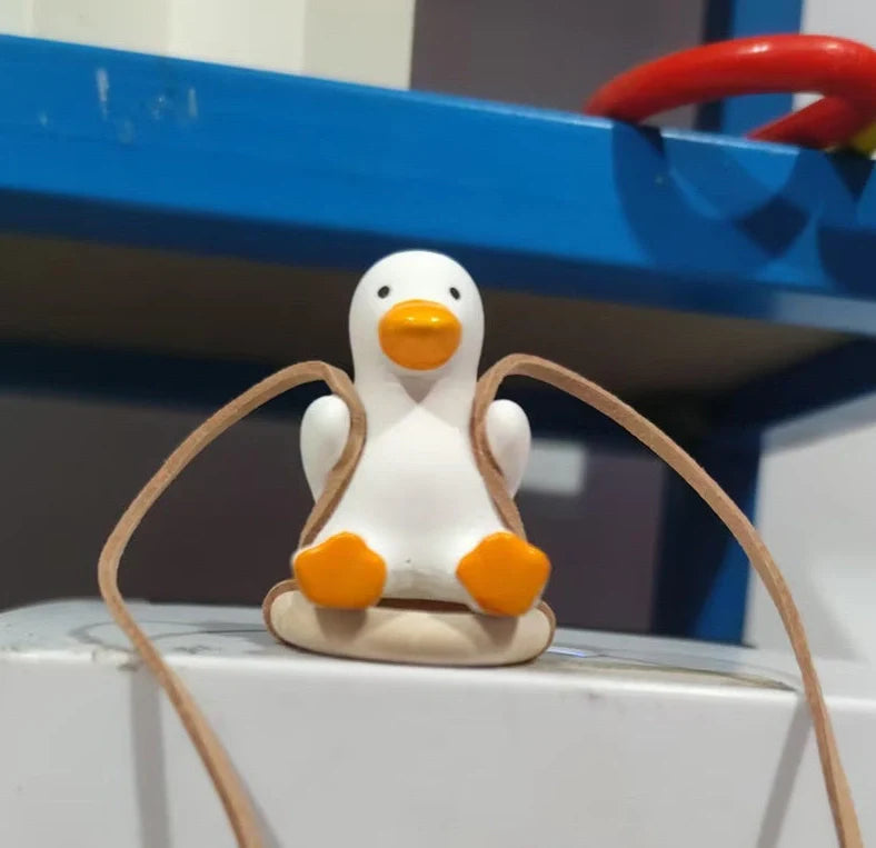 Gypsum duck ornament with swing tire design measuring 6x5x6cm for decorative displays