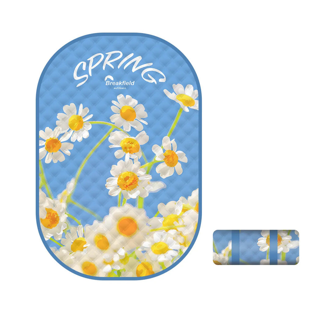 Waterproof thickened outdoor picnic mat in a seasonal colour, laid out on grass.
