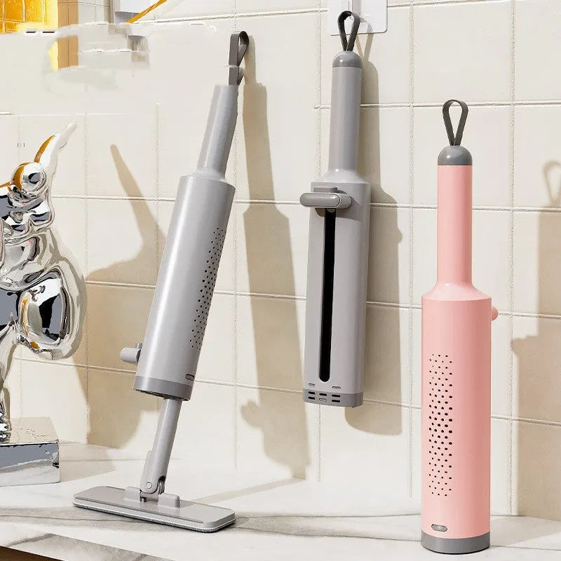 Pink self-squeezing flat mop with rotatable head and microfiber pads for floor cleaning