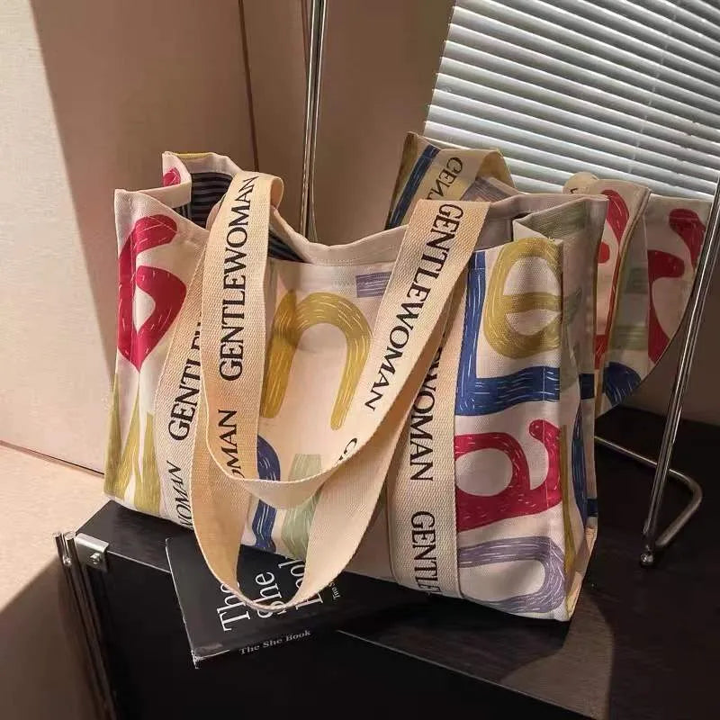 Large canvas women's tote shopping bag with printed design in choice of black letters, coloured letters, or pattern style.