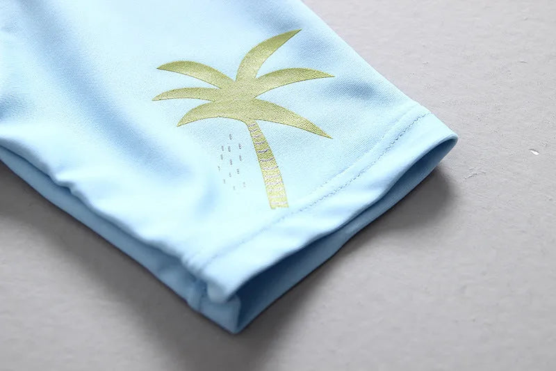 Light green dinosaur print children's nylon swimsuit with matching sun hat for boys