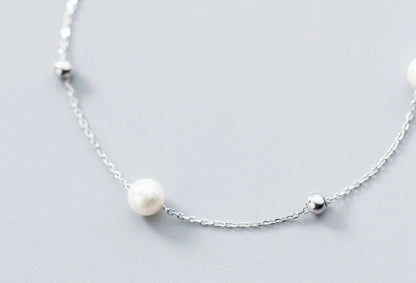 Adjustable synthetic pearl bracelet with 925 silver clasp, perfect for any wrist size