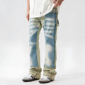 Yellow and blue retro patchwork jeans with splash-ink distressed design on a mid-waist trouser cut.