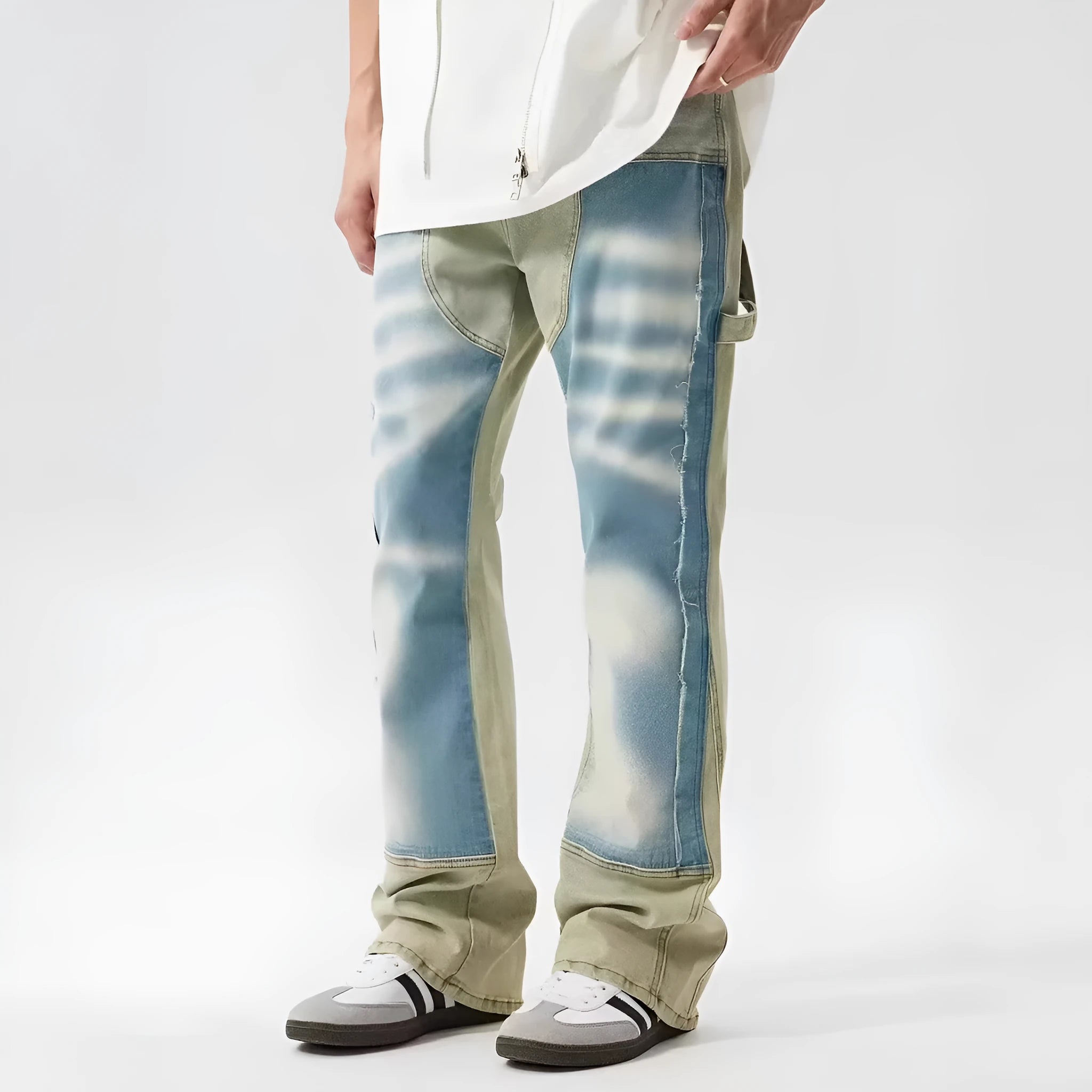Yellow and blue retro patchwork jeans with splash-ink distressed design on a mid-waist trouser cut.