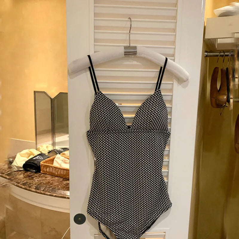 Blue and black one-piece swimsuit for small chest and slim build on a mannequin.