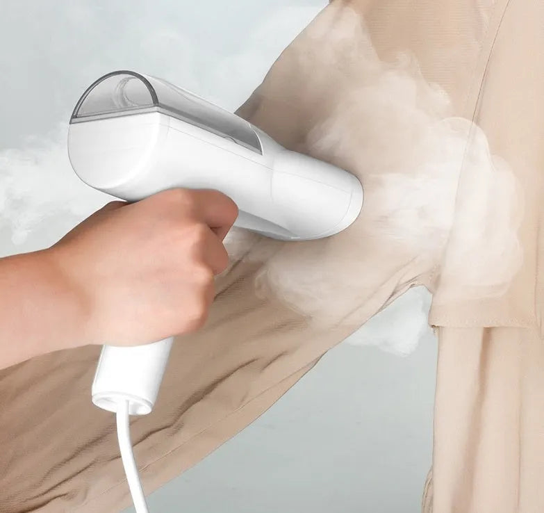 White folding ironing machine with 800W steam function, compact folded size 10cm by 6.2cm by 18cm, includes long hair brush