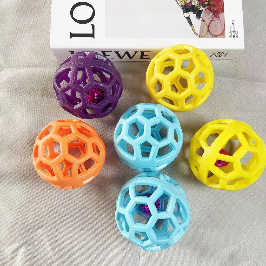 Orange TPR dog chew ball toy 9cm diameter with bell on white background