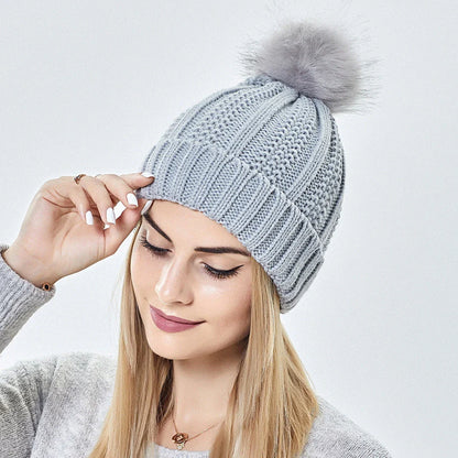 Cozy satin-lined knit beanies with pom poms in various colors for women's winter fashion