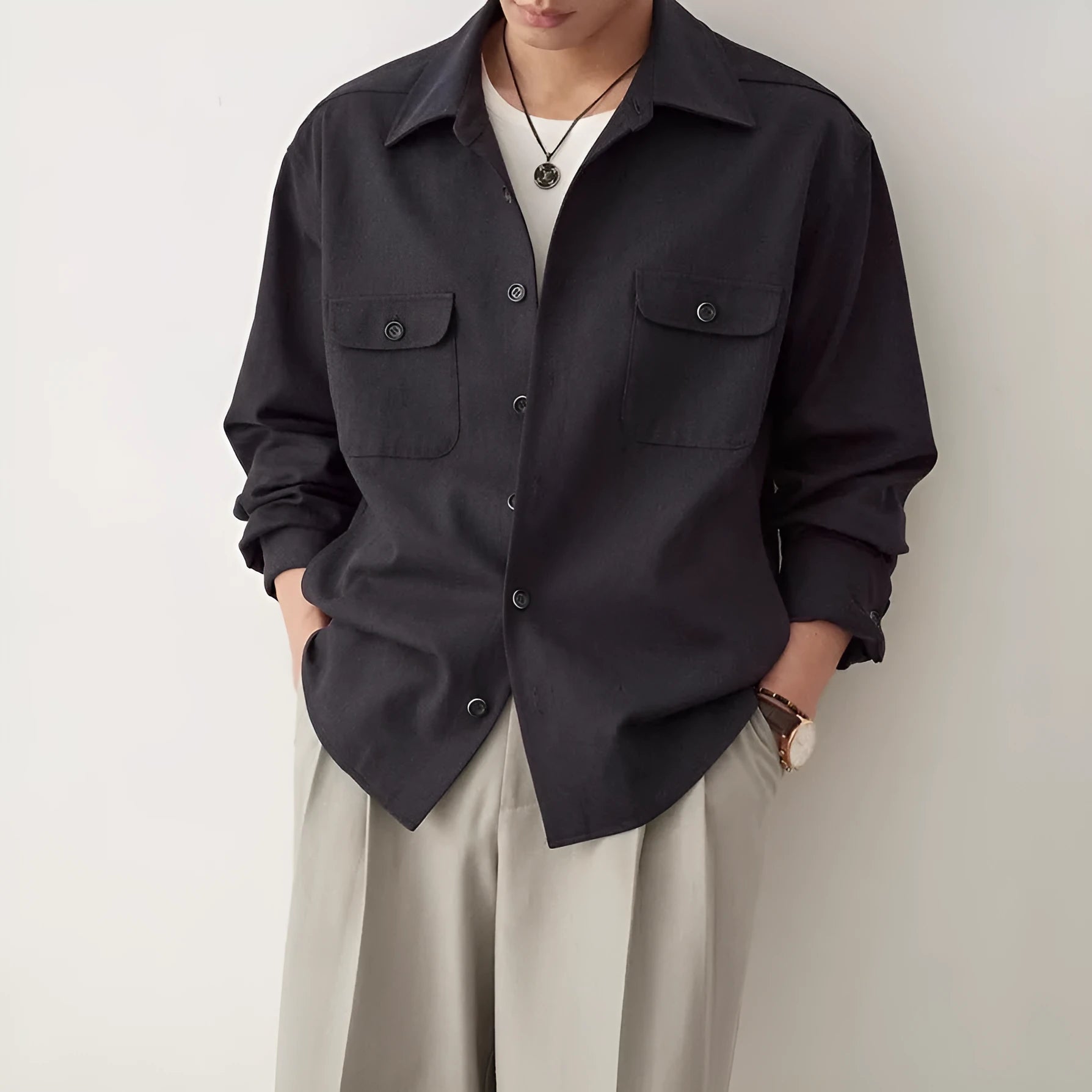 Men's light sand rice coloured casual shirt with simple lapel and long sleeves on a hanger.