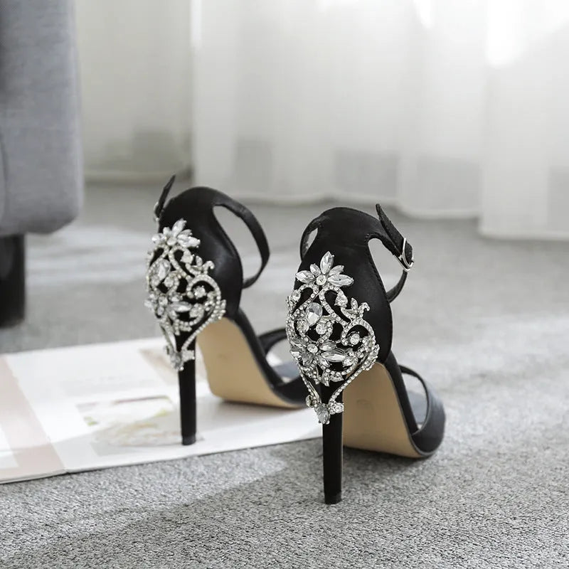 Black suede women's high heel sandals with rhinestone decorations and a fish mouth toe shape.