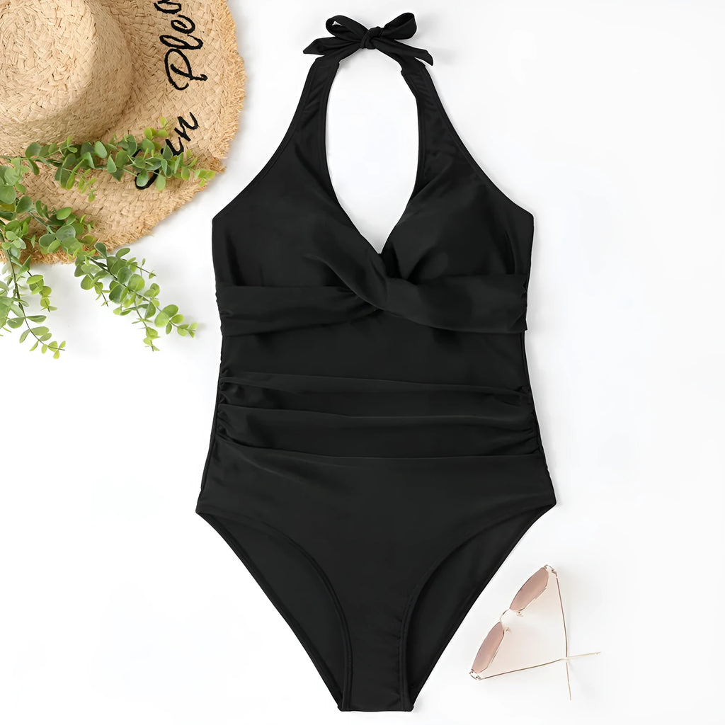 Women's black cross-front one-piece swimsuit laid flat, showing Asian size label.