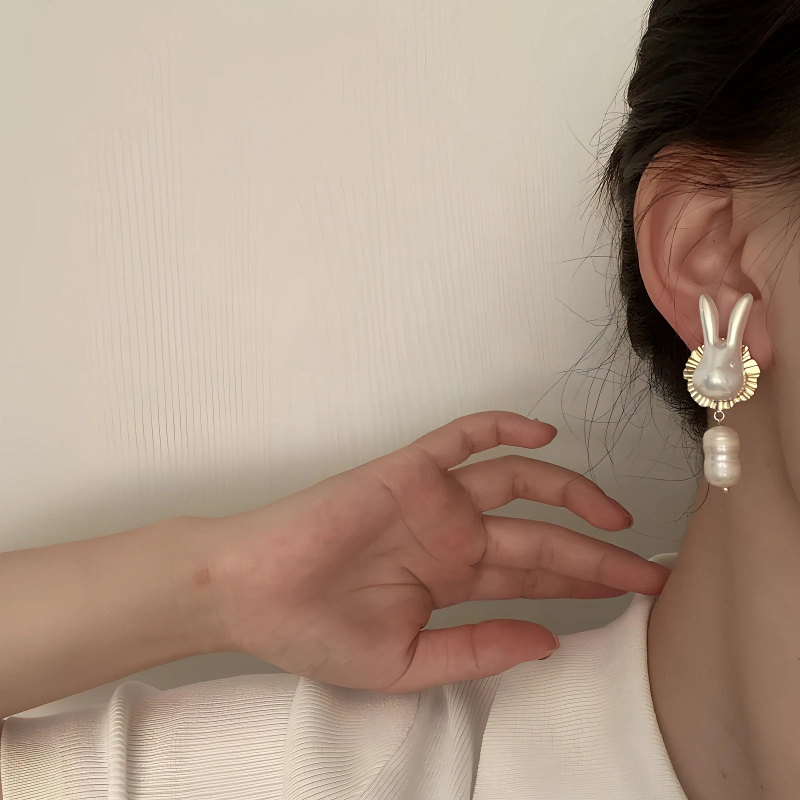 Silver bunny character earrings with baroque pearls measuring 2.5cm length with electroplated finish