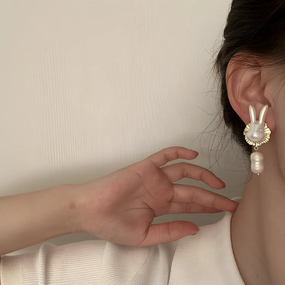 Silver bunny character earrings with baroque pearls measuring 2.5cm length with electroplated finish
