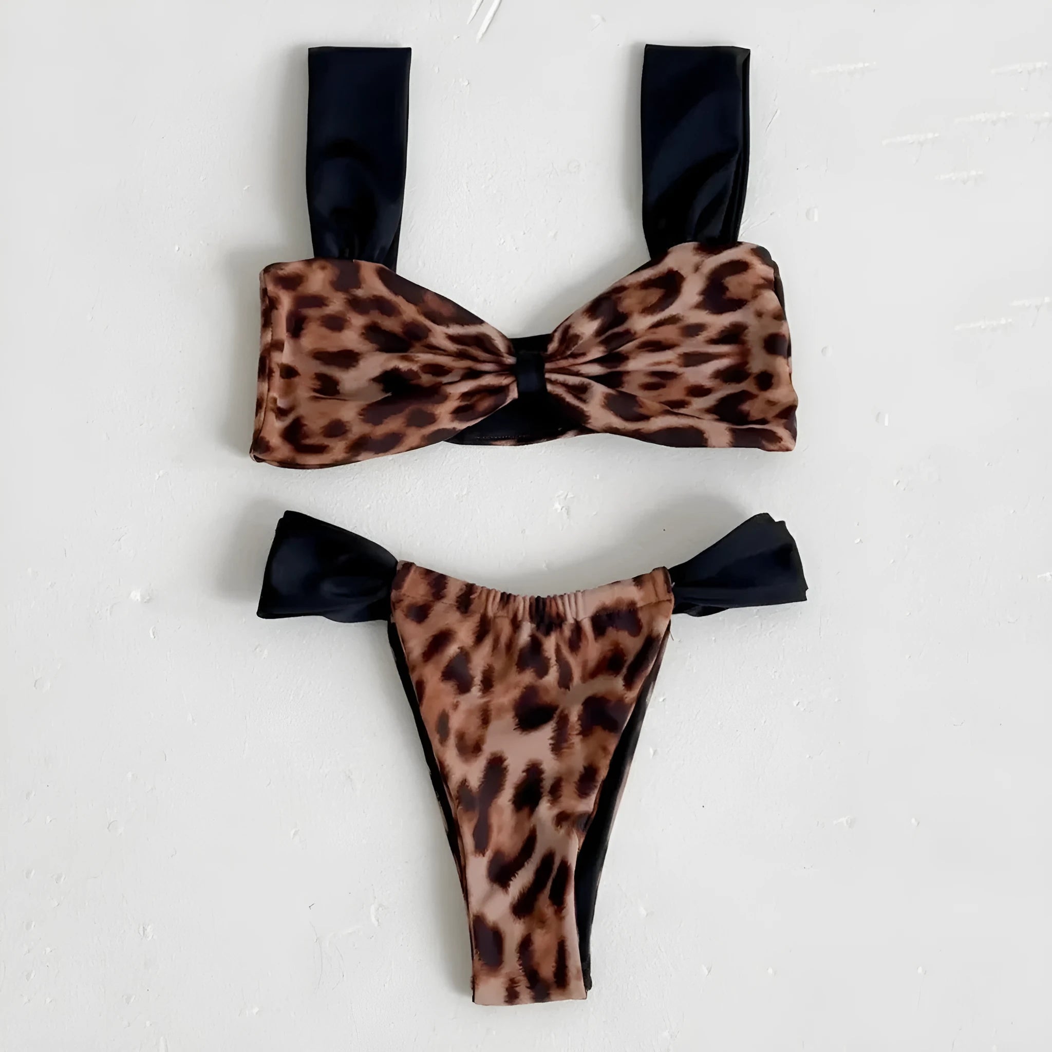 Black women's bikini with leopard print tube top and matching split T-back pant.