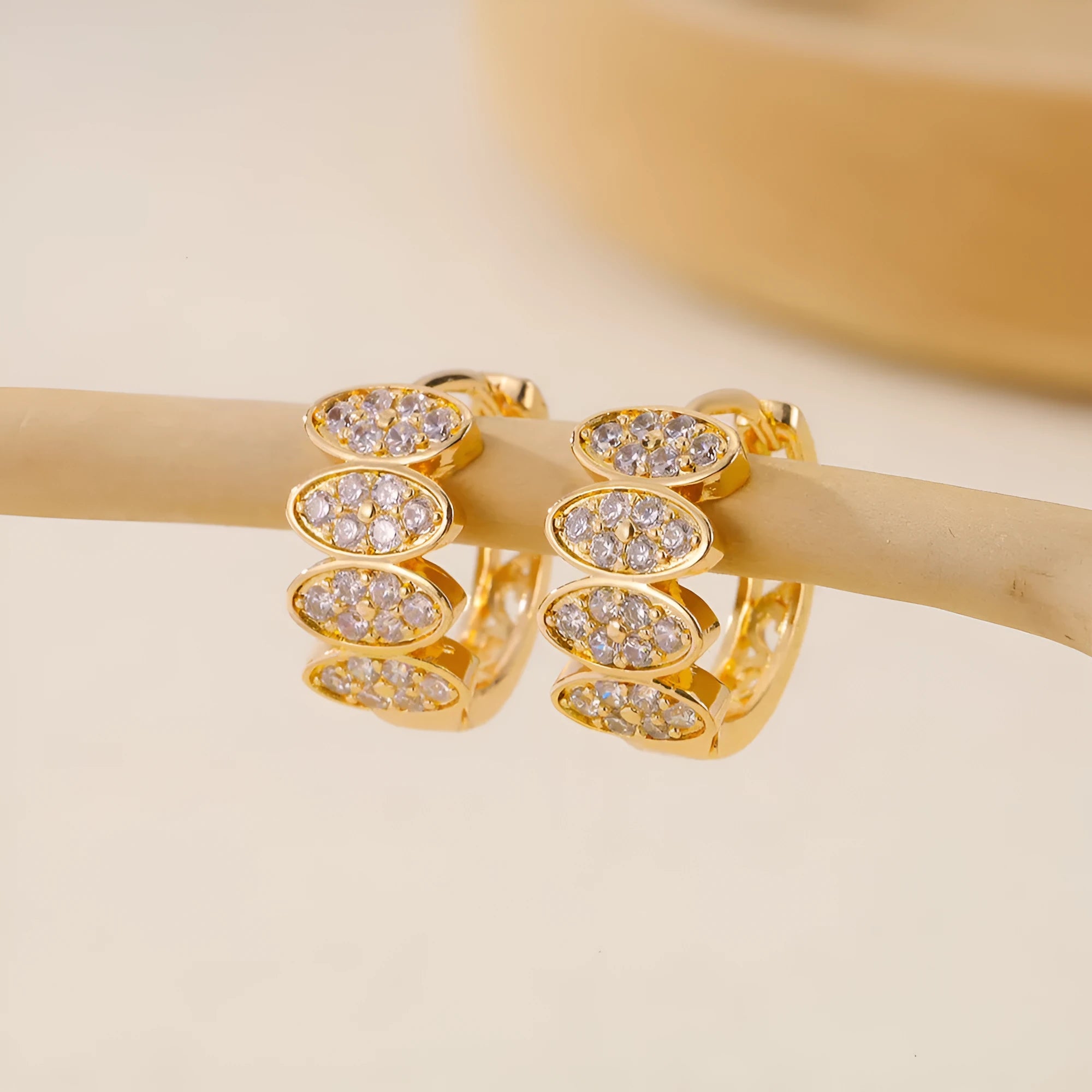 Gold colour women's earrings with zircon stones and zirconium inlay on copper construction