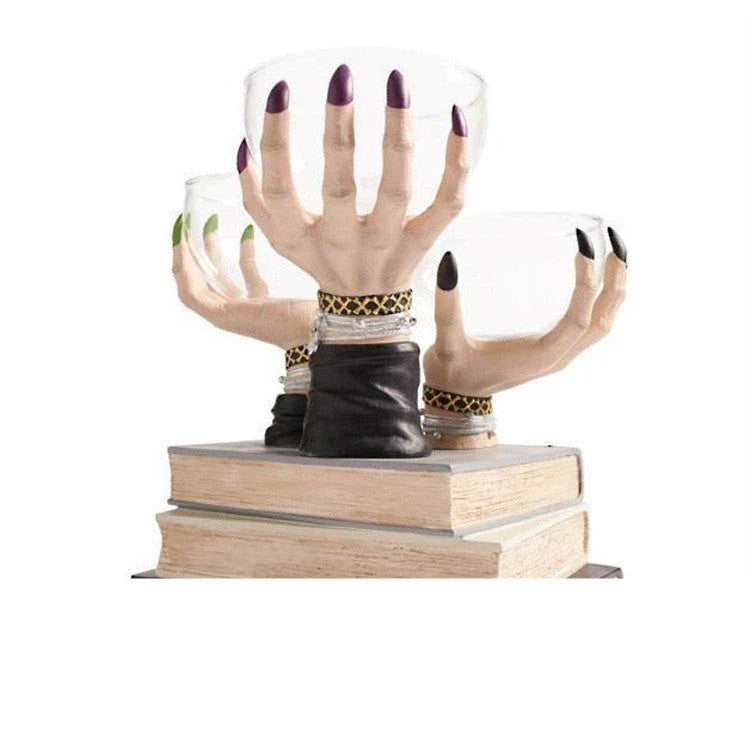 Spooky snack stand with witch hand design and transparent bowls for Halloween party decorations