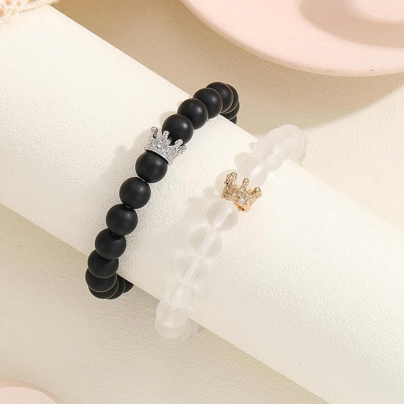 Luminous glow-in-the-dark crown bracelet set in white and black colors, showcasing a unique design and enchanting nighttime glow