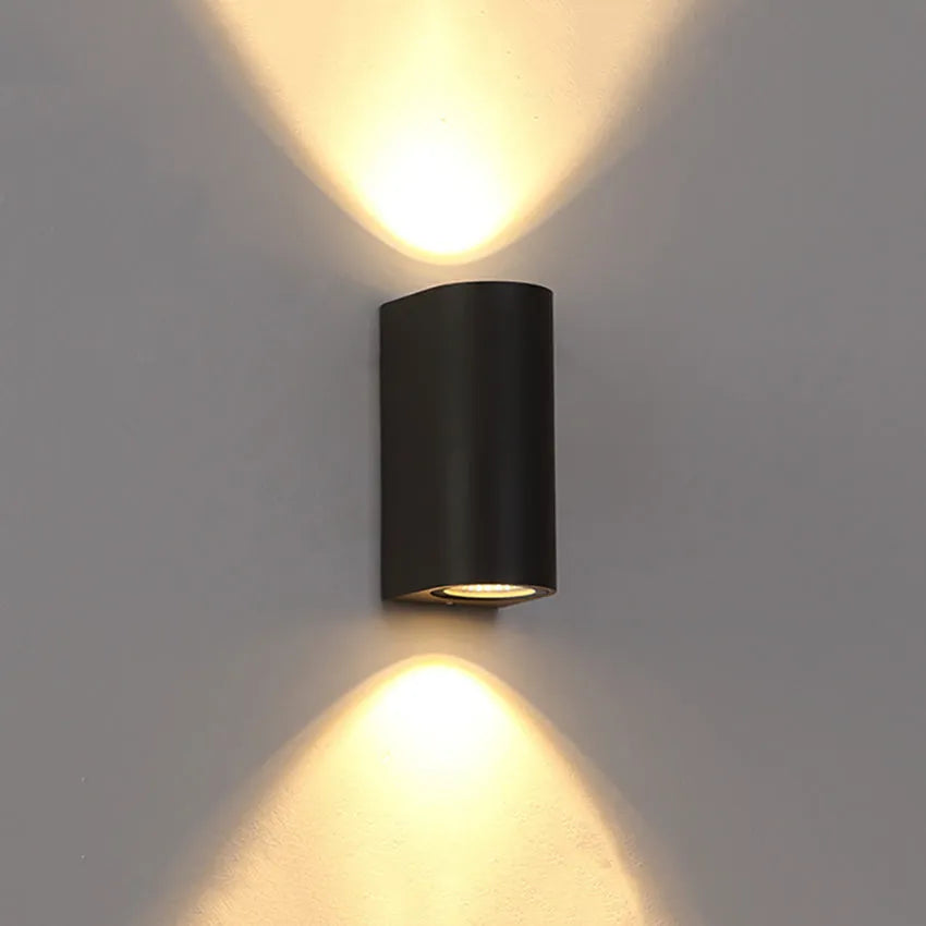 Modern black aluminium and glass wall lamp with silicone rubber detailing and integrated LED light.
